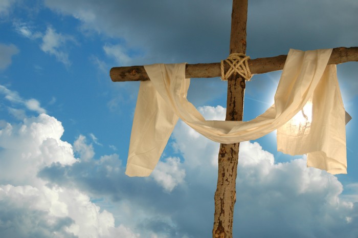 Cross and cloth against backlit blue sky